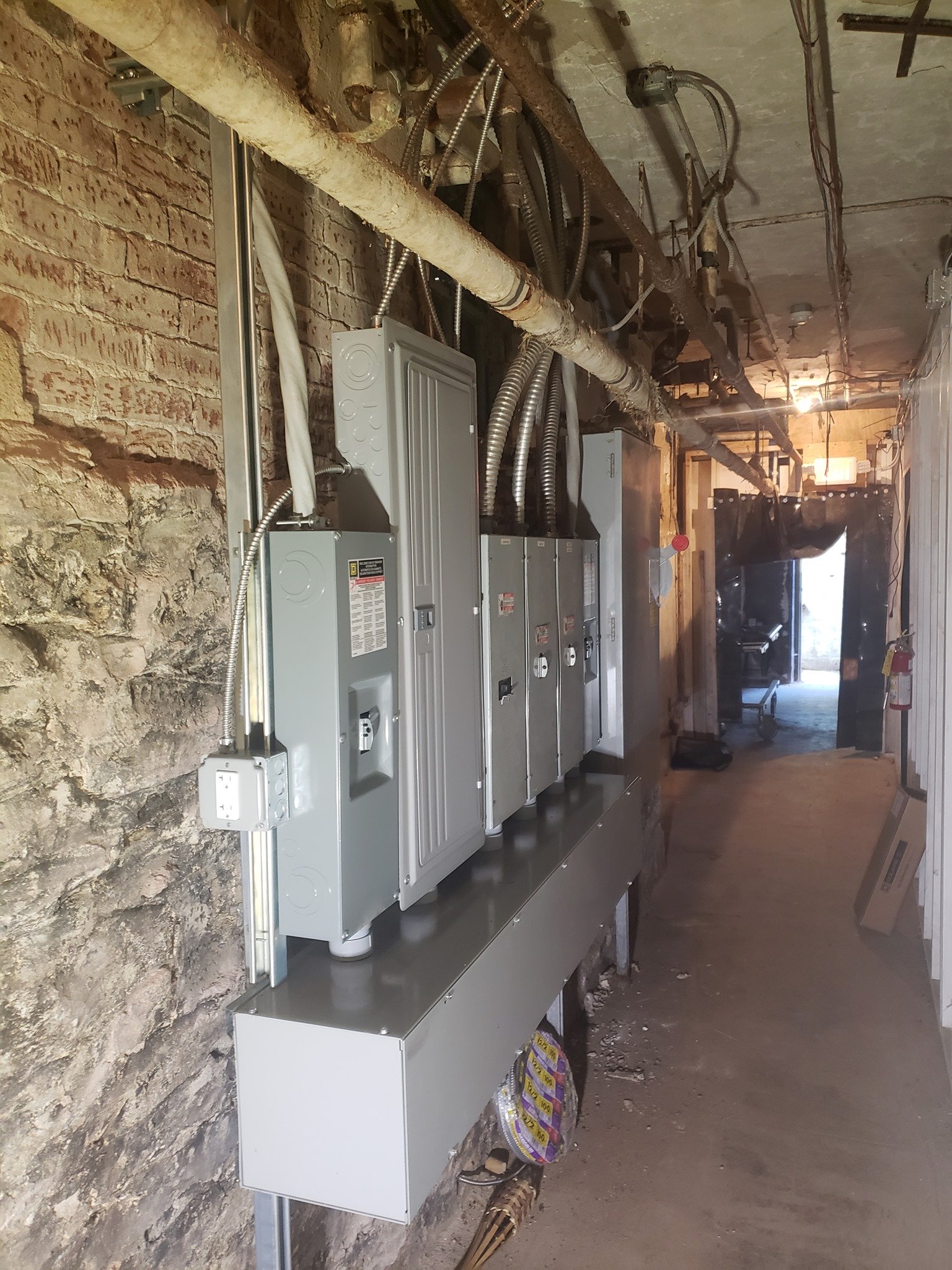 Row of commercial sub-panels installed by Geib's Electric