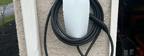 Level 2 EV charger installed on a garage wall by Geib's Electric